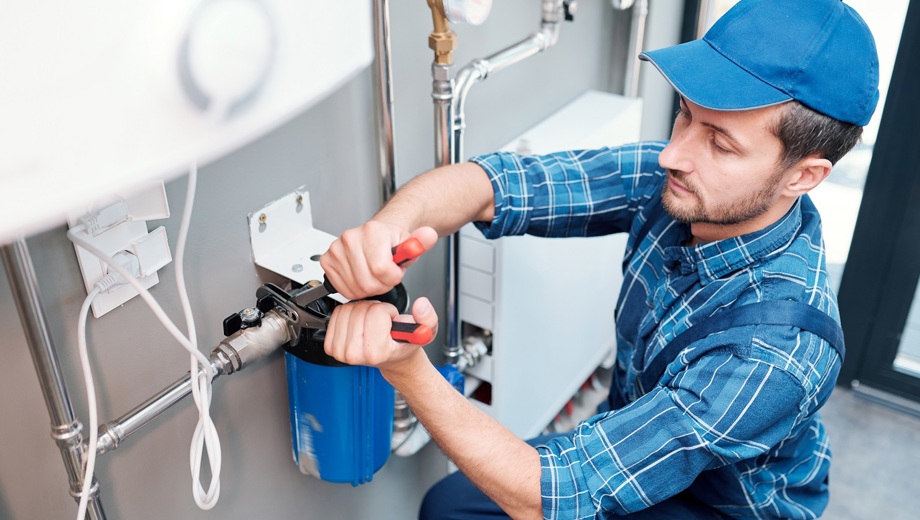 KLEIN 23 Young Man Workwear Using Pliers While Installing Water Filtration System Kitchen Client