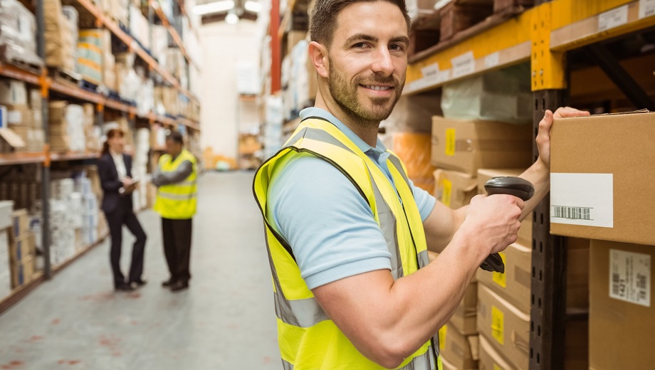 147 Warehouse Worker Scanning Box While Smiling Camera Verkleinert